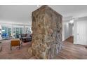 Living room with a floor-to-ceiling rock column feature, ceiling fan, and neutral decor at 115 Lake Pines Ct, Roswell, GA 30076