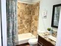 Bathroom showcasing a tub and shower with neutral colored tiling, a modern vanity, and a mirror at 200 Renaissance Ne Pkwy # 304, Atlanta, GA 30308