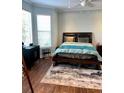 Cozy bedroom featuring a bed with a dark wooden frame, ceiling fan, and a bright window at 200 Renaissance Ne Pkwy # 304, Atlanta, GA 30308