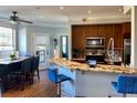 Open concept kitchen with granite countertops, stainless appliances, and adjacent dining area at 200 Renaissance Ne Pkwy # 304, Atlanta, GA 30308