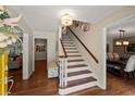 Welcoming entryway features hardwood floors, decorative lighting, staircase, and seamless access to living and dining areas at 3912 Edenton Ne Ct, Brookhaven, GA 30319