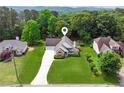 Aerial view of a beautiful property showcasing its lush green lawn and charming facade at 3935 Hamilton View Way, Dacula, GA 30019