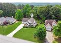 Aerial shot showcasing a well-maintained house with green lawns and tree coverage at 3935 Hamilton View Way, Dacula, GA 30019