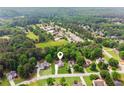 Aerial view of a neighborhood with tree-lined streets and lake nearby at 3935 Hamilton View Way, Dacula, GA 30019
