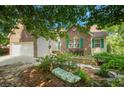 Charming brick home with green shutters, landscaped yard and stone path with bench at 1740 Ambercrest Pl, Buford, GA 30518