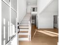 Bright and airy foyer with hardwood floors, a staircase, and modern finishes throughout at 205 Carrington Pt, Canton, GA 30115