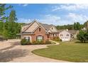 Beautiful house with attached garage, long driveway and well-manicured lawn overlooking a tranquil lake at 2191 Lakeview Pkwy, Villa Rica, GA 30180