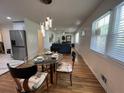 Open-concept living and dining area with hardwood floors and stylish lighting at 2833 Oldknow Nw Dr, Atlanta, GA 30318