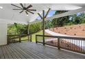 Relaxing covered back porch with wood floors, ceiling fan, and views of the landscaped backyard at 6835 Sunny Brook Ln, Atlanta, GA 30328