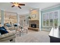 Comfortable living room with a stone fireplace, plush seating, and natural light from shuttered windows at 3920 Ineal Dr, Cumming, GA 30028
