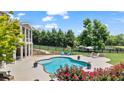 Backyard pool area with lush landscaping, lounge chairs, and a view of the surrounding greenery at 3920 Ineal Dr, Cumming, GA 30028