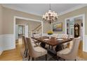 Traditional dining room featuring a chandelier, hardwood floors, and elegant decor at 4810 Duncans Lake Dr, Buford, GA 30519