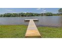 Lake view featuring a wood dock extending onto the water from a grassy shoreline at 4810 Duncans Lake Dr, Buford, GA 30519