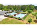 Aerial view of community pool, playground, and tennis courts surrounded by mature trees at 4810 Duncans Lake Dr, Buford, GA 30519