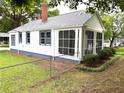 This home features a screened-in porch, brick chimney, and fenced-in yard at 5091 Newark Ave, Clarkdale, GA 30111