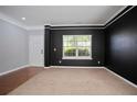 Neutral room with light carpet, black accents and natural light at 5244 Carrington Park Dr, Powder Springs, GA 30127