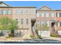 Attractive townhomes featuring brick facades, private garages, and landscaped front yards at 12084 Cotton Aly, Alpharetta, GA 30009