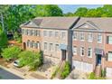 Lovely townhomes with brick exteriors, garage parking, and meticulously maintained landscaping at 12084 Cotton Aly, Alpharetta, GA 30009