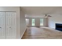 Open-concept living area featuring new laminate flooring and a cozy fireplace at 5326 Nader Pl, Stone Mountain, GA 30088