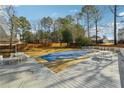 Backyard view with a large covered pool, picnic tables, fenced yard, and mature trees at 360 Wynbrook Dr, Mcdonough, GA 30253
