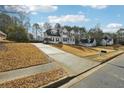 Traditional two-story home with a long driveway and well-manicured front lawn at 360 Wynbrook Dr, Mcdonough, GA 30253
