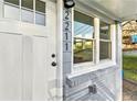 Inviting front entrance with a white door, updated exterior lighting, and fresh paint at 2211 Macon Sw Dr, Atlanta, GA 30315