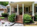 A well-maintained front porch with wood steps, railing, and manicured landscaping at 3078 Alberta Dr, Marietta, GA 30062