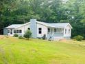 Charming ranch-style home with blue accents and a metal roof at 97 East Rd, Covington, GA 30016