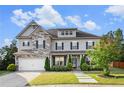 Charming two-story home featuring stone accents, manicured lawn, and an attached two-car garage at 2113 Dodson Woods Dr, Fairburn, GA 30213