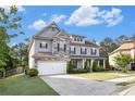 Beautiful two-story home with stone accents, a well-maintained lawn, and a spacious driveway at 2113 Dodson Woods Dr, Fairburn, GA 30213