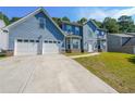 Charming two-story home featuring a two-car garage and long concrete driveway at 6220 Polar Fox Ct, Riverdale, GA 30296