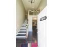 Bright, welcoming foyer with hardwood floors and staircase featuring decorative railing at 6220 Polar Fox Ct, Riverdale, GA 30296