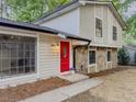 Charming two-story home with a well-maintained lawn, stone accents and bright red front door at 8007 Northcrest Dr, Jonesboro, GA 30238