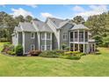 Rear exterior view of the house with a screened-in porch and large backyard at 1064 Highway 20 E, Mcdonough, GA 30252