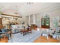 Open-concept living room featuring hardwood floors, a large archway, and cathedral ceiling at 1064 Highway 20 E, Mcdonough, GA 30252