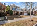 Beautifully landscaped home with a mix of brick and siding exterior at 1481 Wild Rye Ln, Grayson, GA 30017