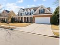 Spacious home featuring a two-car garage, ample parking, and a well-maintained lawn at 1481 Wild Rye Ln, Grayson, GA 30017