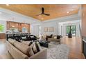 Open-concept living room with hardwood floors, modern furniture, and a view into the kitchen area at 3267 Sewell Mill Rd, Marietta, GA 30062
