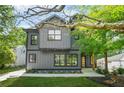 Modern two-story home featuring gray siding, black trim, well-manicured lawn and landscaped front yard at 34 Candler Ne Rd, Atlanta, GA 30317