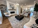 Spacious living room with fireplace, modern furniture, and wood floors at 3167 Moor View Rd # 35, Duluth, GA 30096
