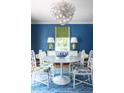 Bright dining room featuring a modern chandelier, dining table with stylish chairs, and blue wallpaper, creating an elegant space at 5205 Riverview Nw Rd, Atlanta, GA 30327