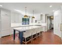 Spacious kitchen with a large island, white cabinetry, and brick flooring at 5205 Riverview Nw Rd, Atlanta, GA 30327
