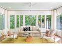 Sun-filled sun room with lots of windows offering peaceful views of nature at 5205 Riverview Nw Rd, Atlanta, GA 30327