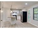 Modern kitchen with white cabinetry, stainless steel appliances, and a convenient island for meal prep at 5429 Martins Crossing Rd, Stone Mountain, GA 30088