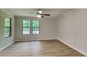 Bright living room with hardwood floors, large windows, and neutral paint perfect for decorating to your style at 5429 Martins Crossing Rd, Stone Mountain, GA 30088