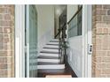 Welcoming foyer with hardwood floors, staircase, and elegant wainscoting at 6294 Century Park Se Pl, Mableton, GA 30126