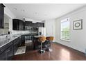 Modern kitchen featuring stainless steel appliances and a breakfast bar with seating at 6294 Century Park Se Pl, Mableton, GA 30126