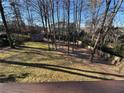 This expansive backyard features a shed and ample space for outdoor activities, partially fenced at 6542 Cherry Tree Ln, Atlanta, GA 30328