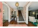 Inviting foyer with hardwood floors, staircase, elegant wallpaper, and decorative lighting at 3086 E Pine Valley Nw Rd, Atlanta, GA 30305