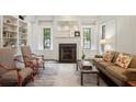 Bright living room with built-in bookshelves, a fireplace, and neutral decor at 603 E Paces Ferry Ne Rd, Atlanta, GA 30305